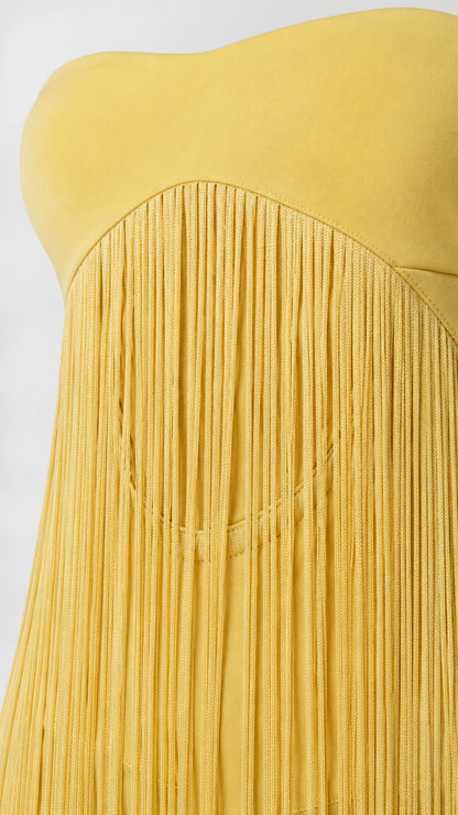 Close-up detail of yellow strapless bodice and fringe texture