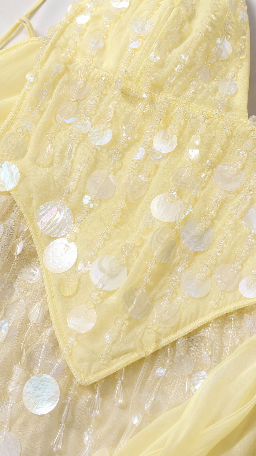 Close-up detail of sequins on yellow dress