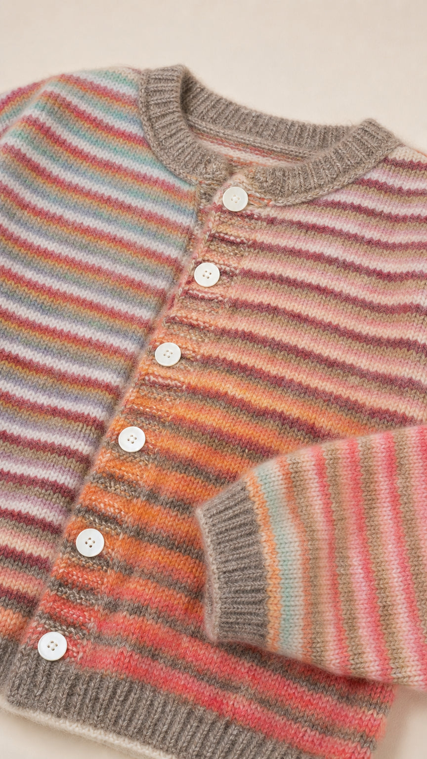 Close-up detail of sunset multi striped knit cardigan with buttons and ribbed crewneck
