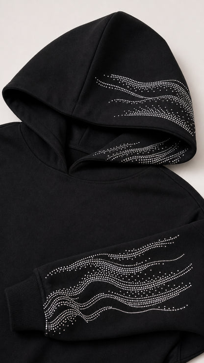 Close-up detail of rhinestone wave embellishments on hood and sleeve