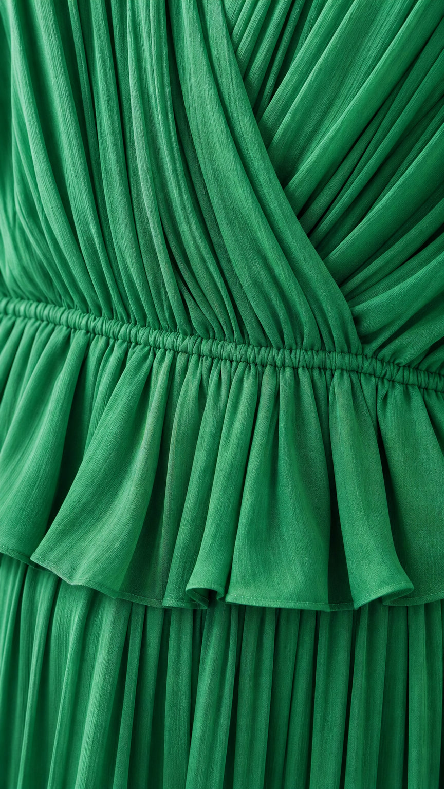 Close-up detail of pleated crossover bodice and ruffled waist