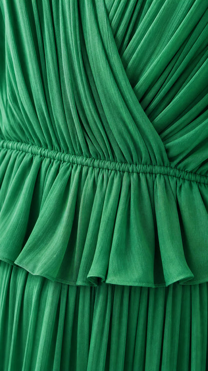 Close-up detail of pleated crossover bodice and ruffled waist