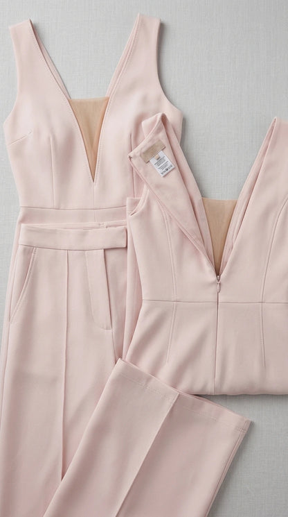 Detailed flat lay of blush pink jumpsuit construction and zipper