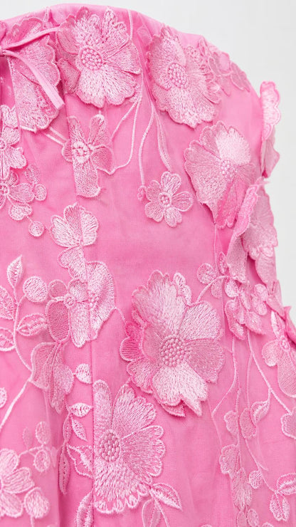 Close-up detail of pink 3D floral embroidery and appliques