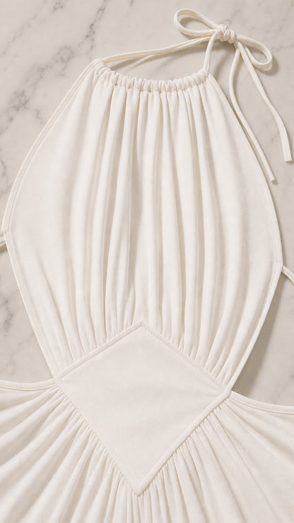 Close-up detail of the gathered bodice and waist cutout on the white dress