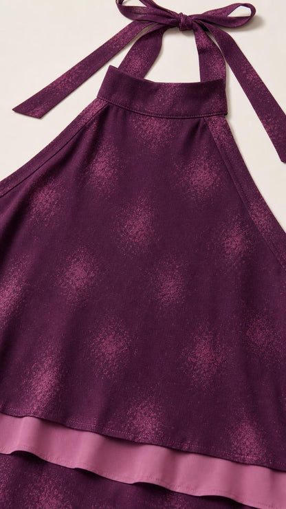 Close-up detail of purple halter neckline and layered fabric texture
