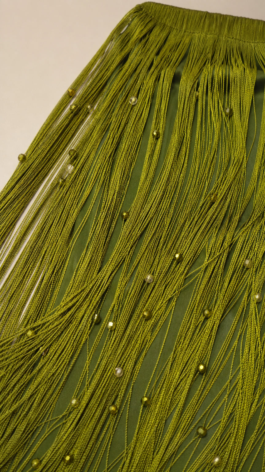 Close-up detail of olive green fringe and bead embellishments