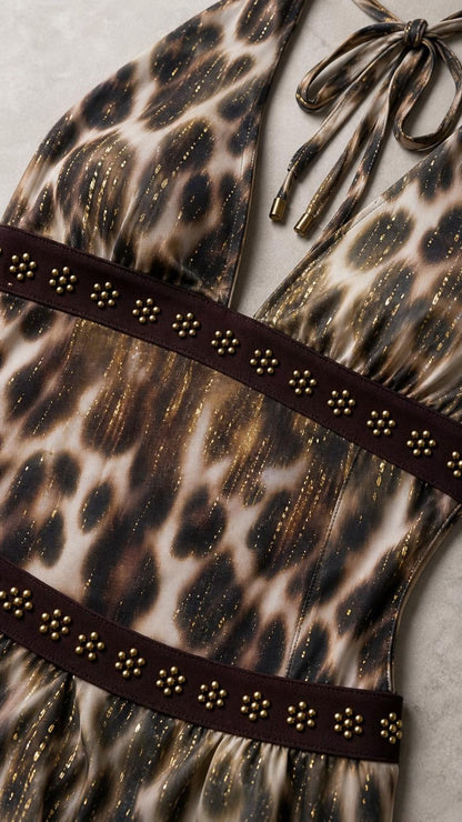 Close-up detail of studded waistband and textured leopard print fabric