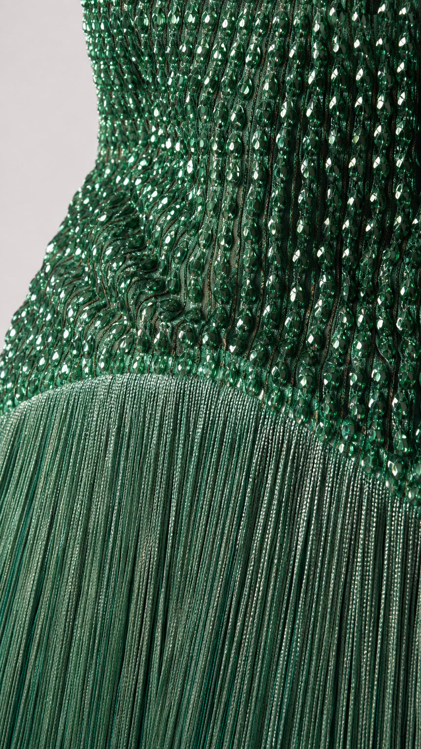 Close-up detail of bodice beadwork and fringe transition