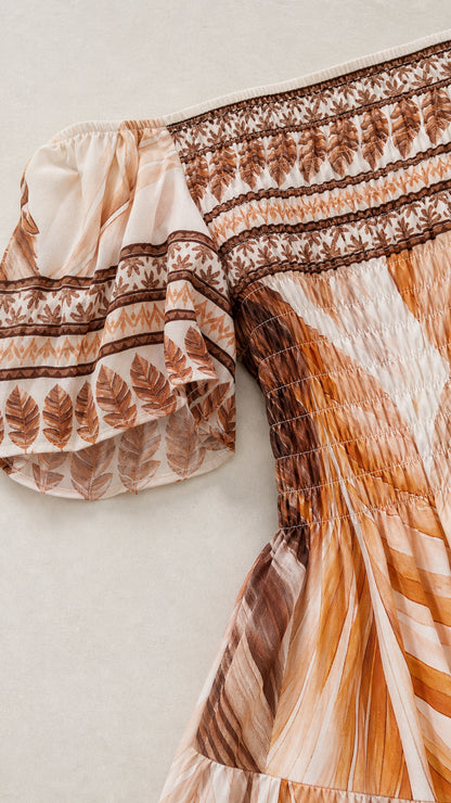 Close-up detail of smocked bodice and patterned puff sleeve
