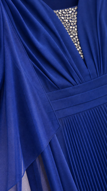Close-up of rhinestone embellished V-neckline and pleats on royal blue evening dress