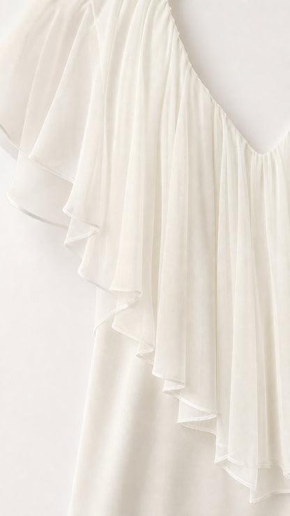 Close-up detail of sheer layered ruffle fabric on white crop top