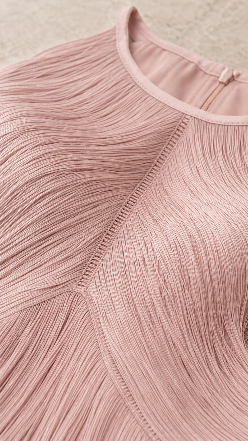 Close-up detail of blush pink high neckline and chevron fringe stitching
