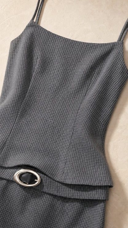 Close-up detail of textured fabric and belted peplum waist