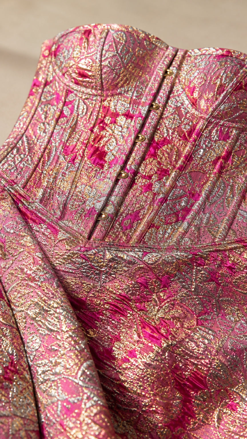Close-up detail of structured corset bodice and metallic fabric