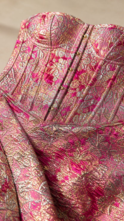 Close-up detail of structured corset bodice and metallic fabric