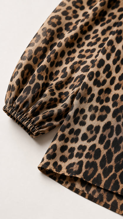 Close-up detail of the sleeve cuff and leopard print fabric texture