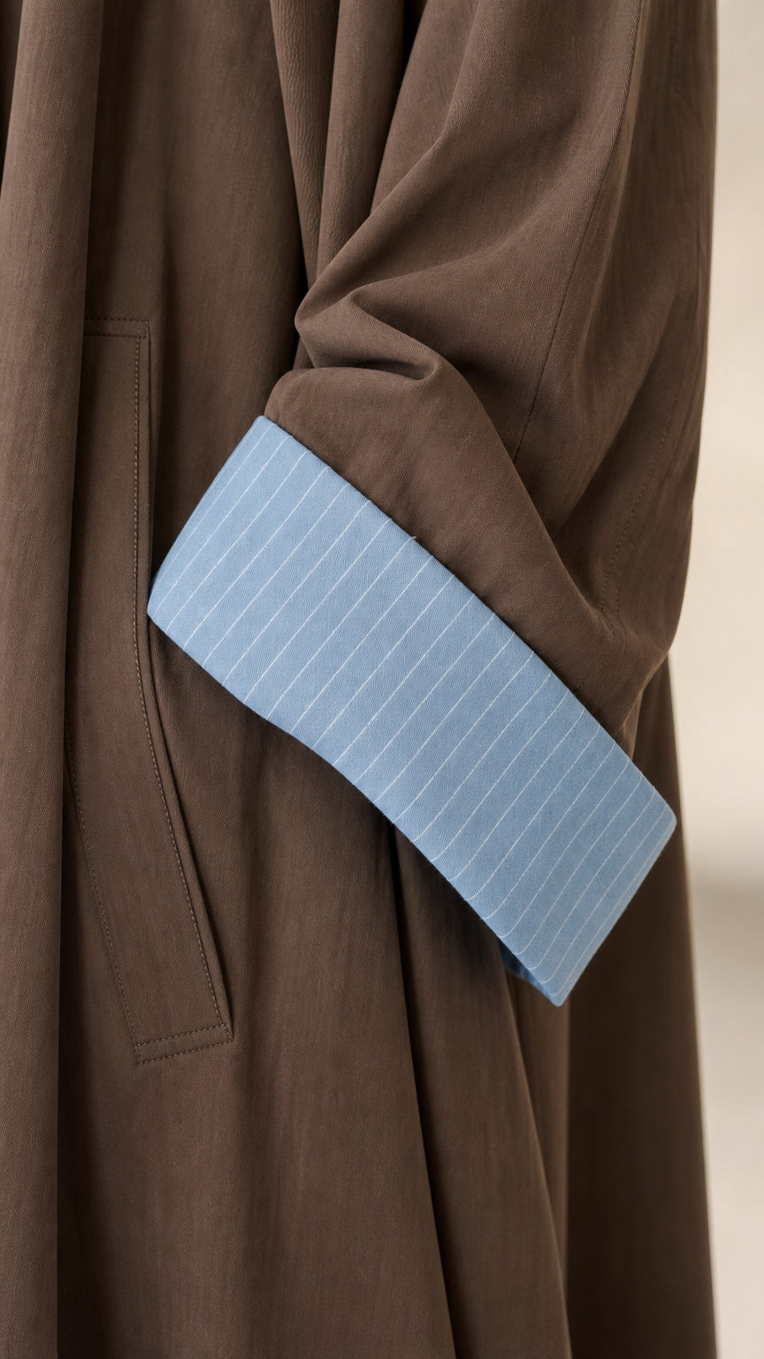 Close-up detail of Mocha Brown sleeve cuff with light blue pinstripe lining