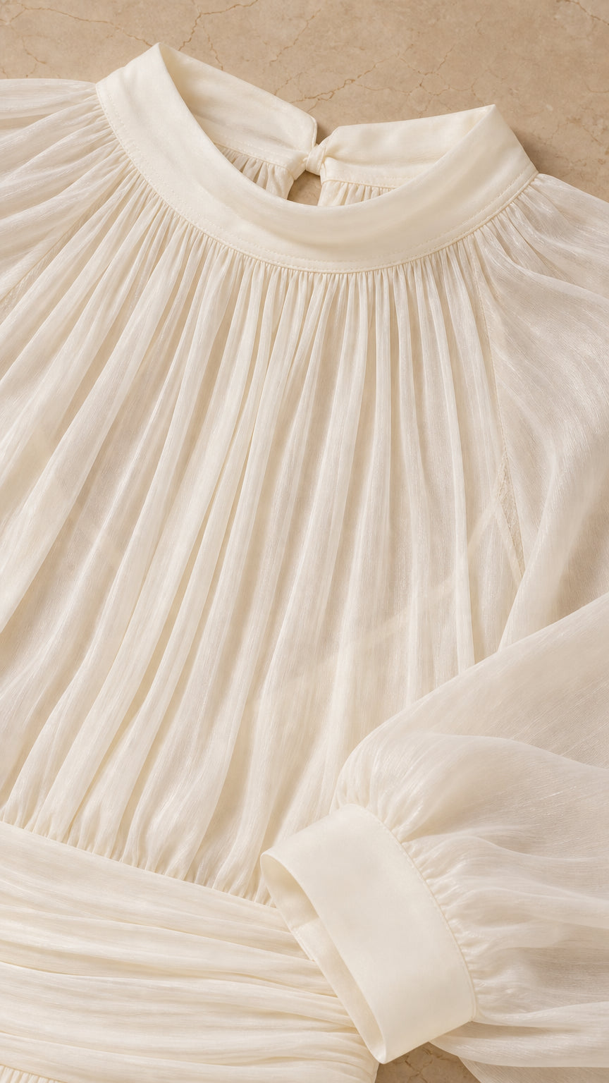 Close-up detail of the high gathered neckline and sleeve cuff