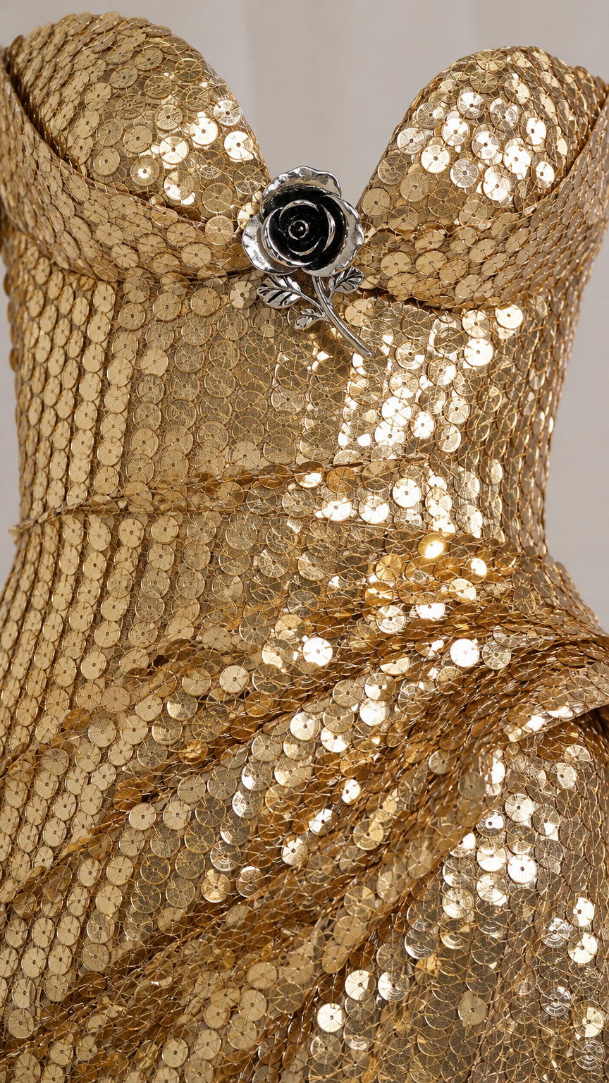 Close-up detail of sequin texture and center brooch accent