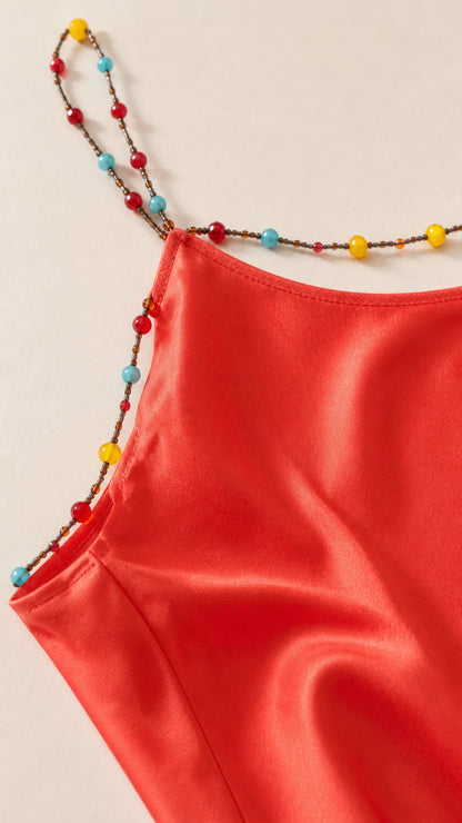 Close-up of colorful beaded straps on Red dress
