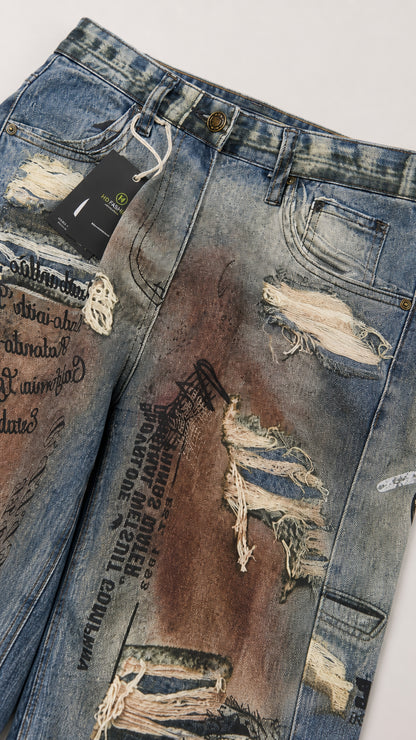 Close-up detail of ripped denim fabric with typography print and vintage wash