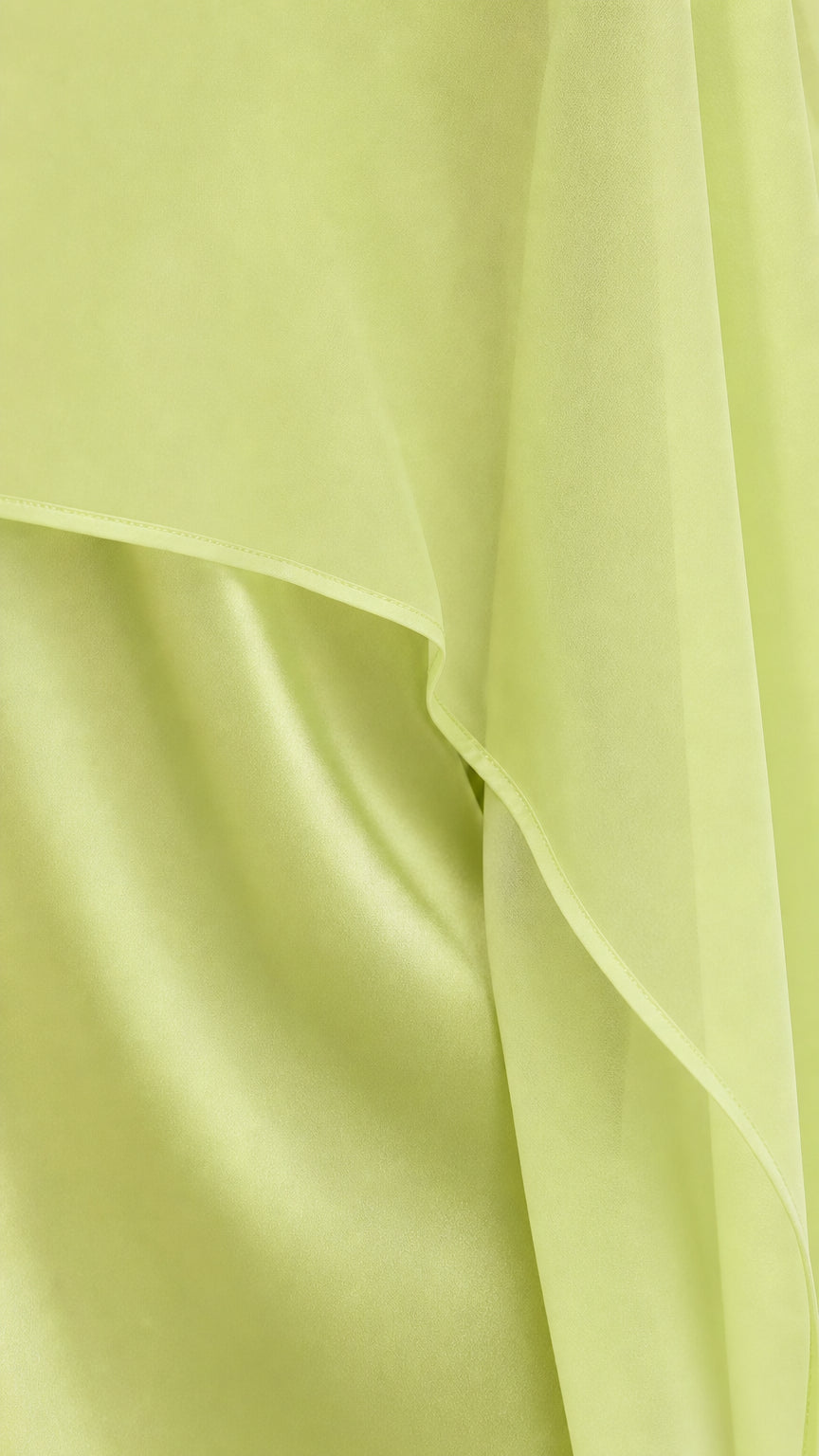 Close-up detail of sheer lime green chiffon overlay and satin fabric