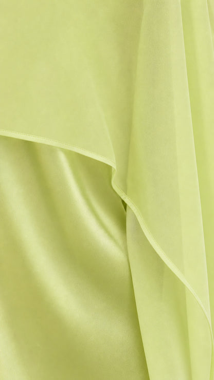 Close-up detail of sheer lime green chiffon overlay and satin fabric