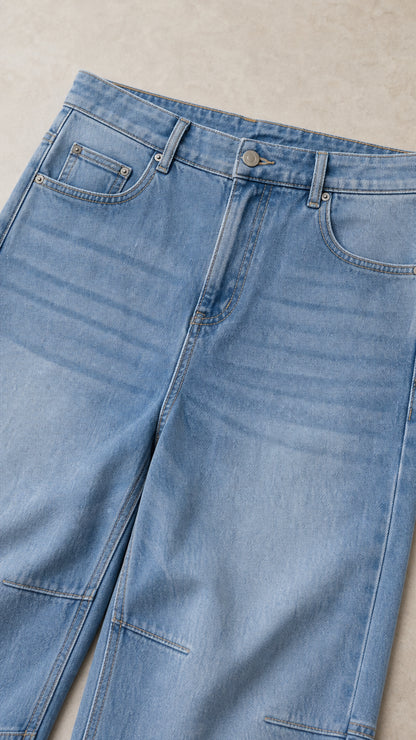 Close-up detail of Light Blue denim waistband, front pockets, seam stitching, and zip fly