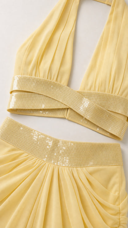 Close-up detail of yellow sequin crossover crop top and waistband