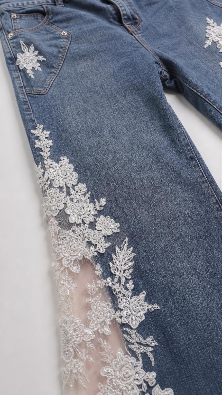 Close-up detail of white floral lace insert on blue denim