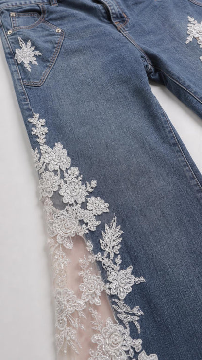 Close-up detail of white floral lace insert on blue denim