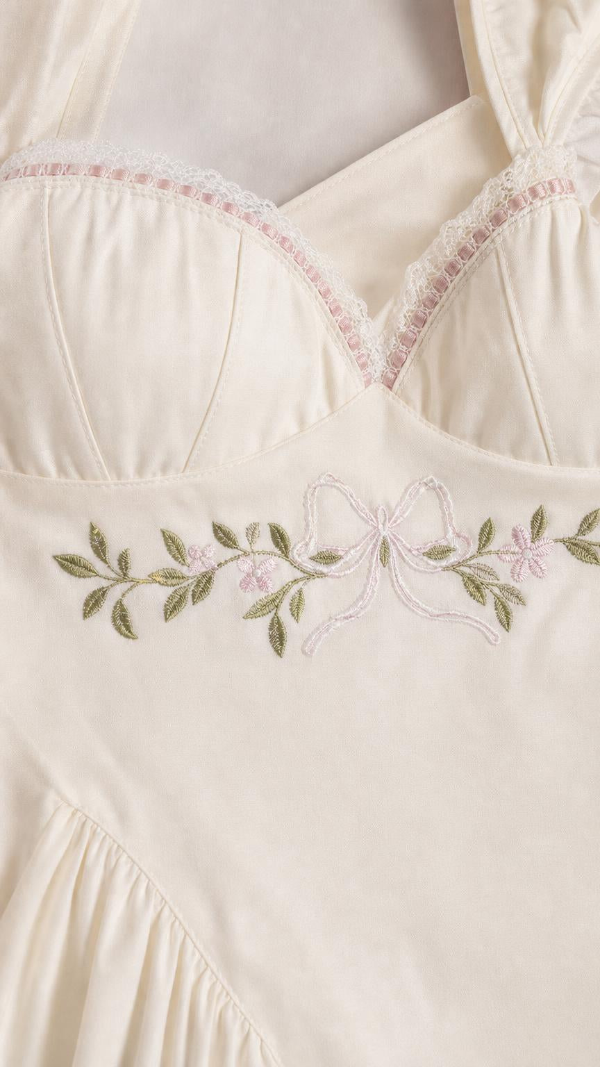 Close-up detail of sweetheart neckline and floral embroidery