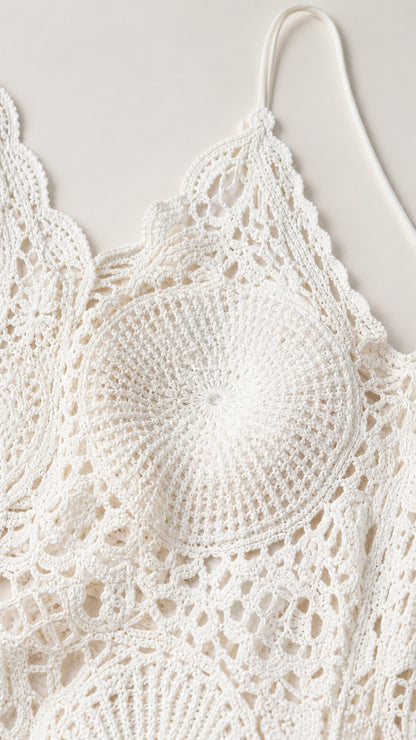 Close-up detail of white crochet lace medallion stitch and scalloped strap
