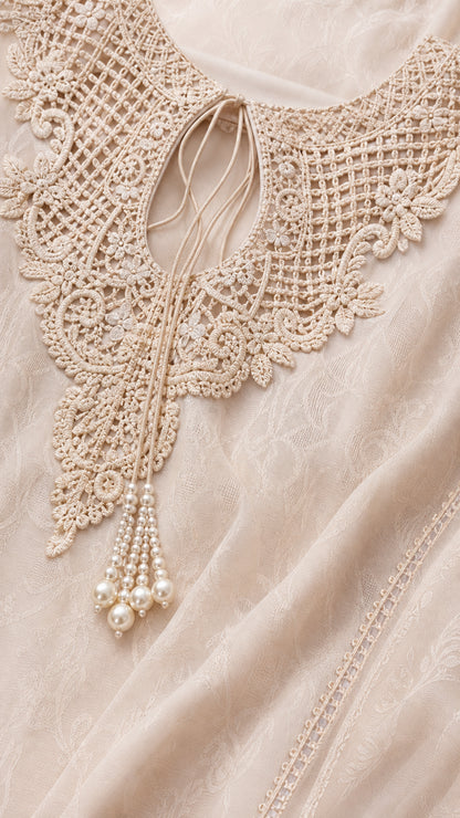 Close-up detail of crochet lace neckline and pearl tassel ties
