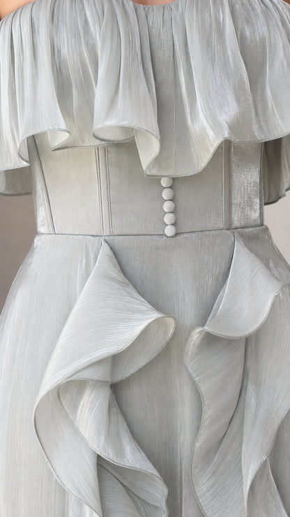Close-up of bodice, buttons, and ruffle details on the sage green gown