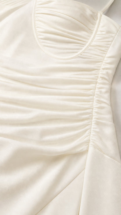 Close-up detail of white ruched bodice and fabric texture