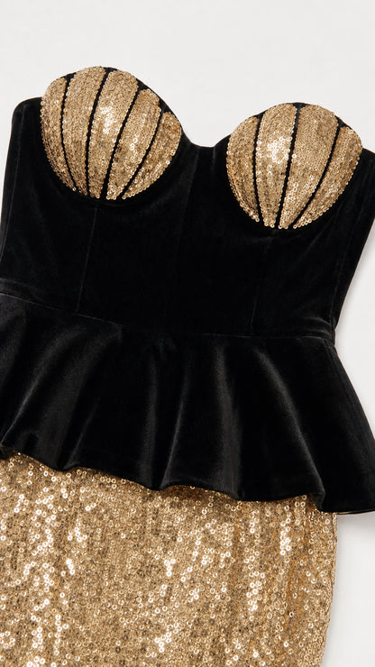 Close-up of gold shell bust and black velvet peplum