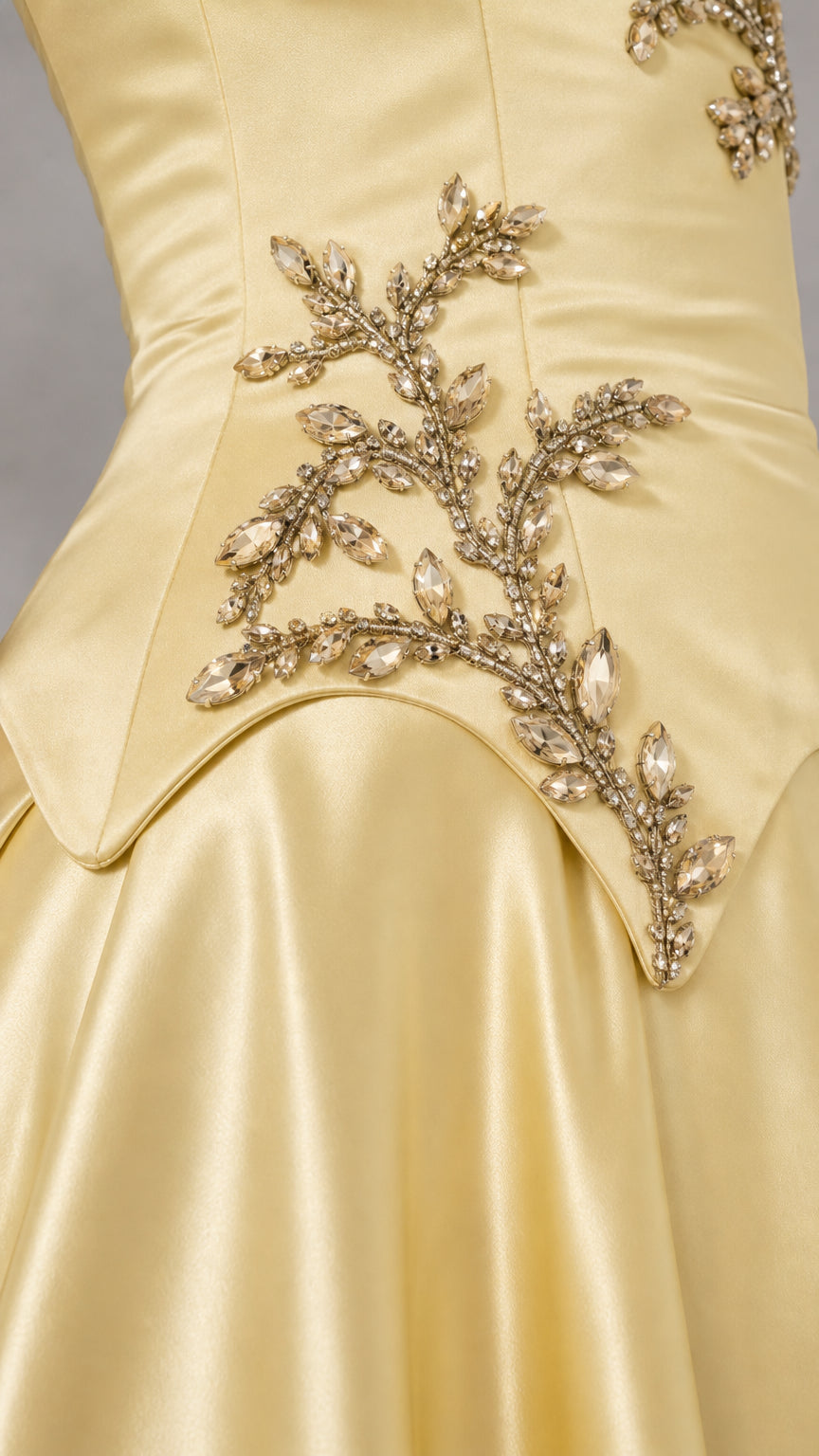Close-up detail of sparkling crystal and bead branch embroidery on the basque waist