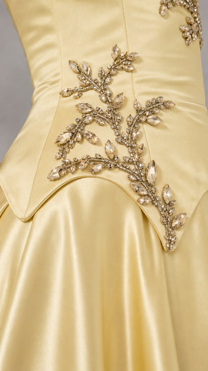 Close-up detail of sparkling crystal and bead branch embroidery on the basque waist