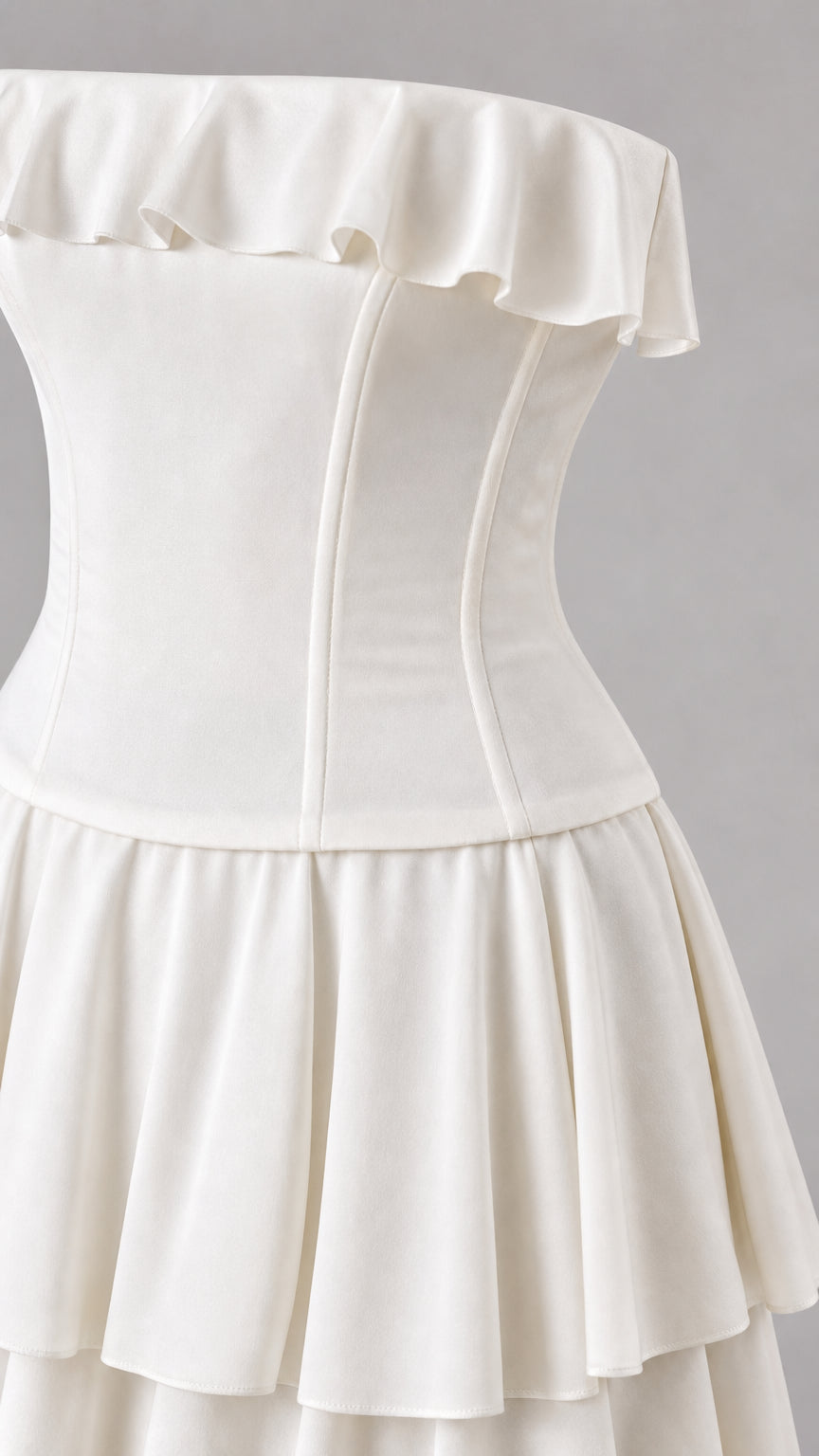 Close-up detail of structured bodice and ruffled neckline