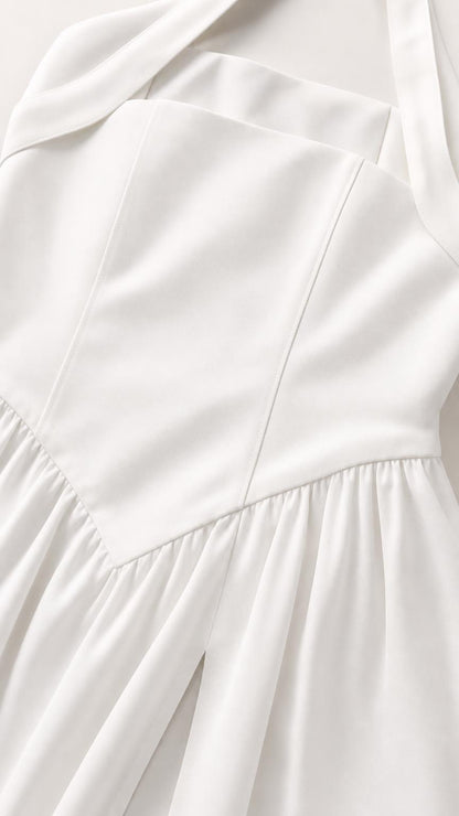 Close-up detail of the structured bodice and fabric on white dress