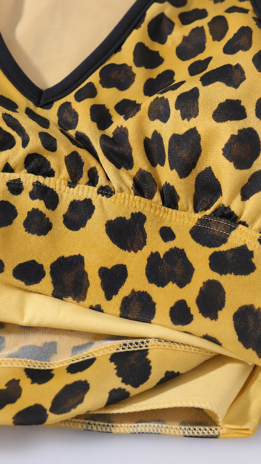 Close-up of fabric texture and print detail of yellow leopard print dress