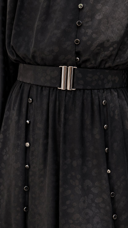 Close-up of black dress belt and button details