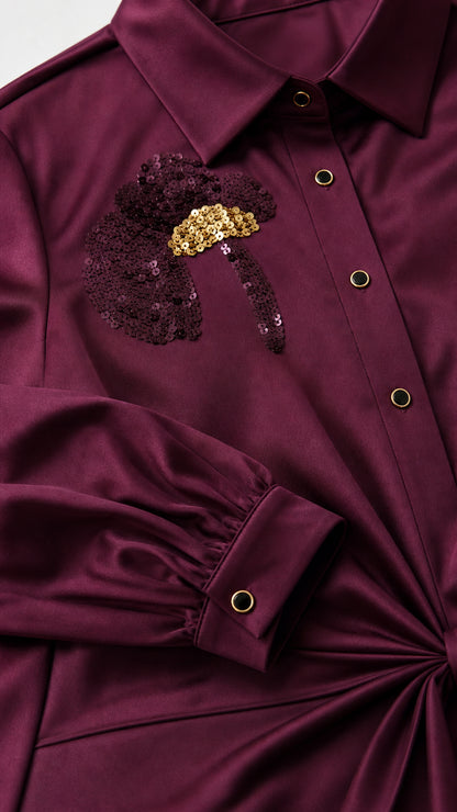 Close-up of burgundy shirt dress collar, button front, cuff, and sequin floral detail