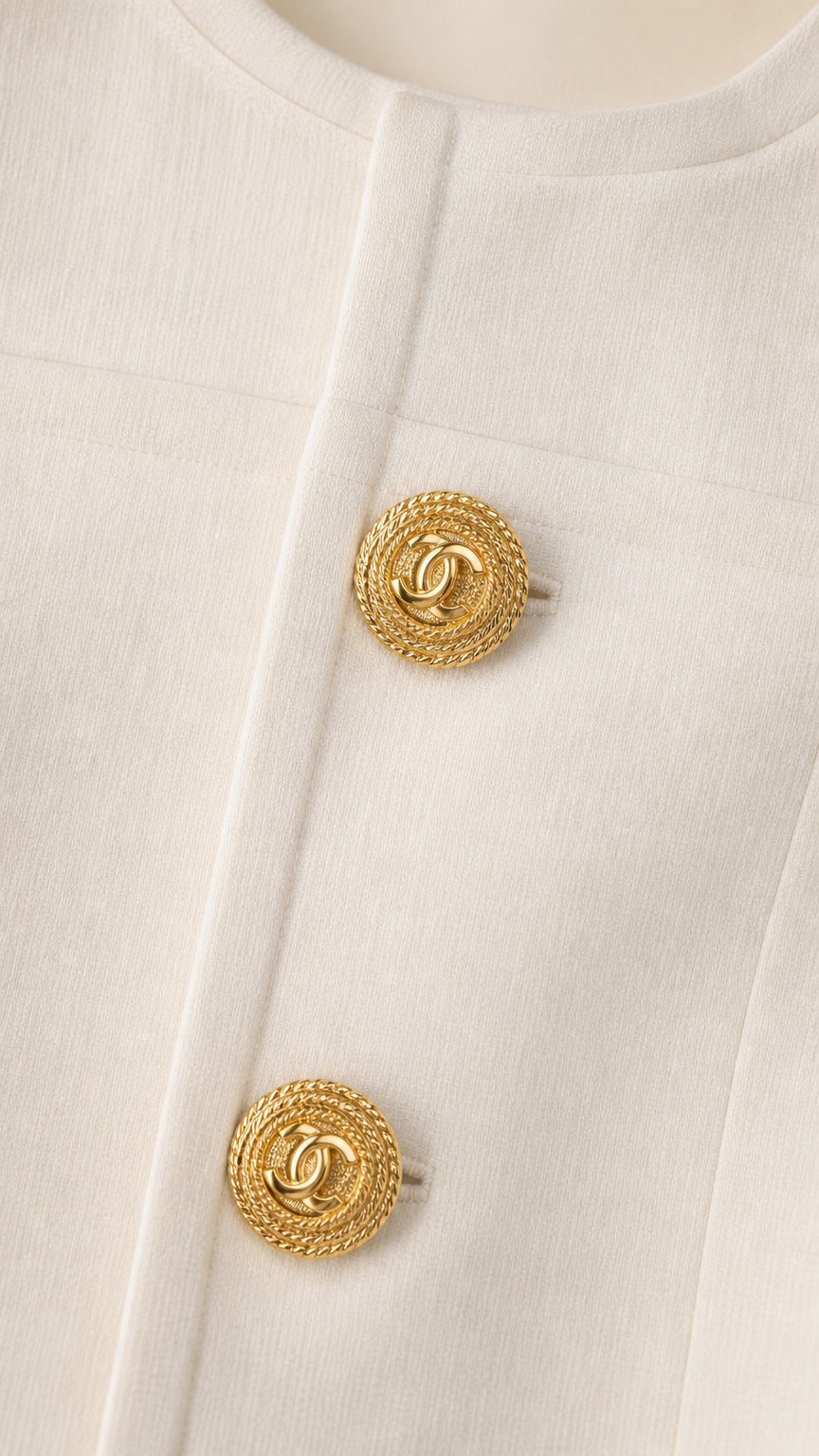 Close-up detail of gold buttons on white jacket