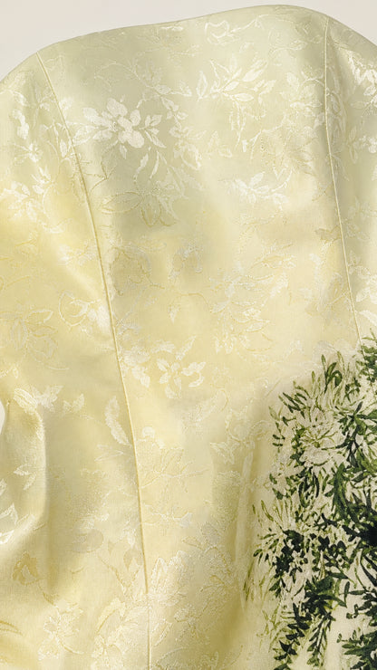 Close up fabric texture detail of yellow jacquard dress