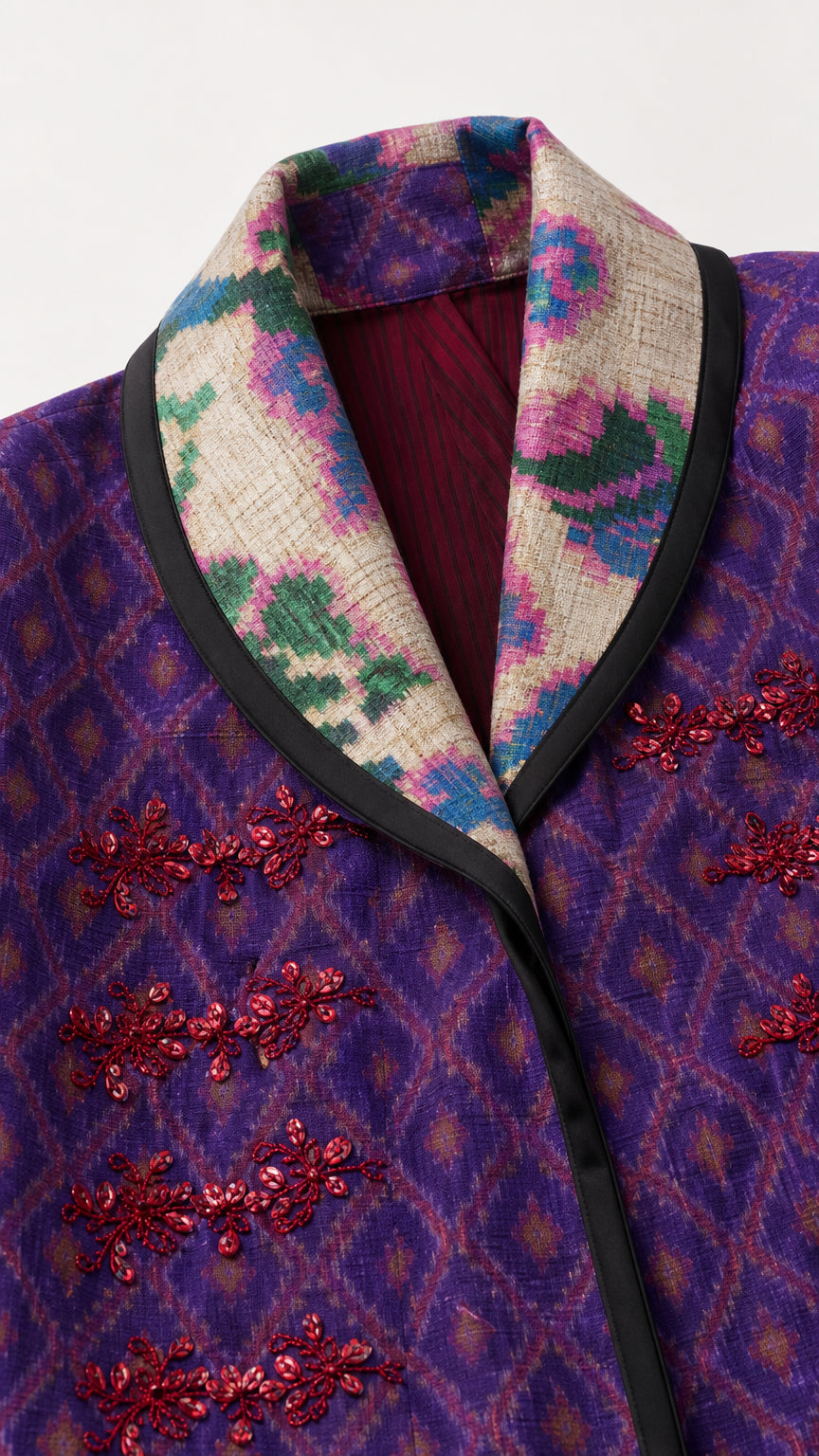 Close-up of the patterned contrast collar and decorative front closures
