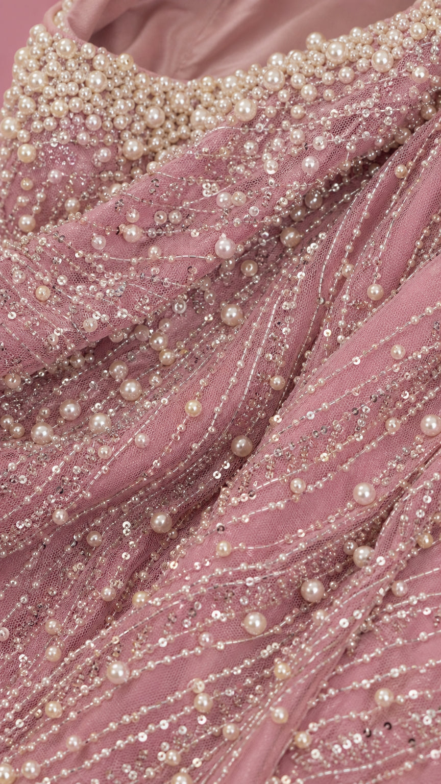Close-up of pearl and bead embellishments on pink mesh fabric