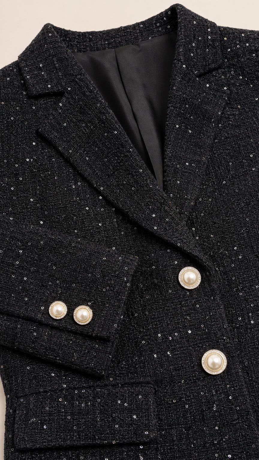 Close-up of black tweed blazer lapel and buttons